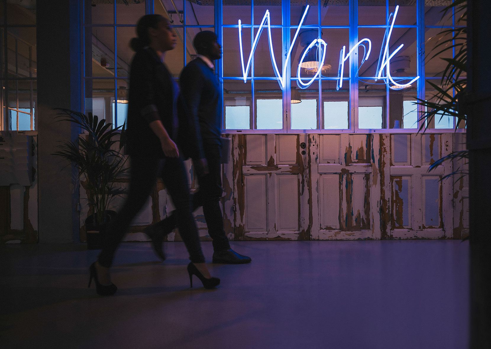 young-business-people-walking-through-office-corridor-with-neon-light-work-sign_razF4rNtl.jpg